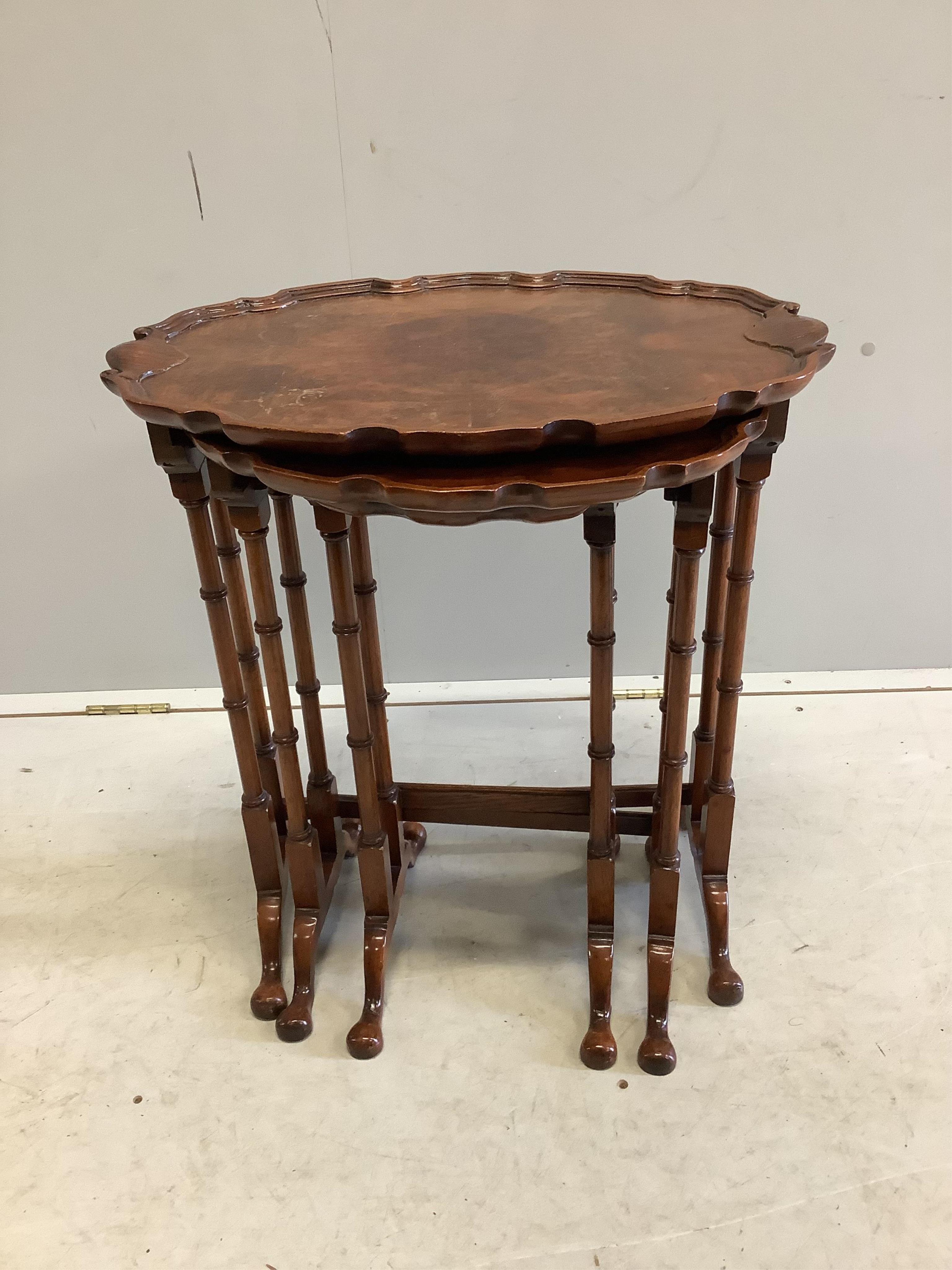 A nest of three burr walnut oval tea tables, width 56cm, depth 38cm, height 62cm. Condition - fair